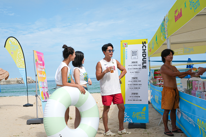 강원도 양양 죽도해변에서 진행되는 '세븐일레븐 2023 양양 서핑페스타'에 참여한 관광객들이 부스에서 하이볼을 구매하고 있다. 사진=세븐일레븐